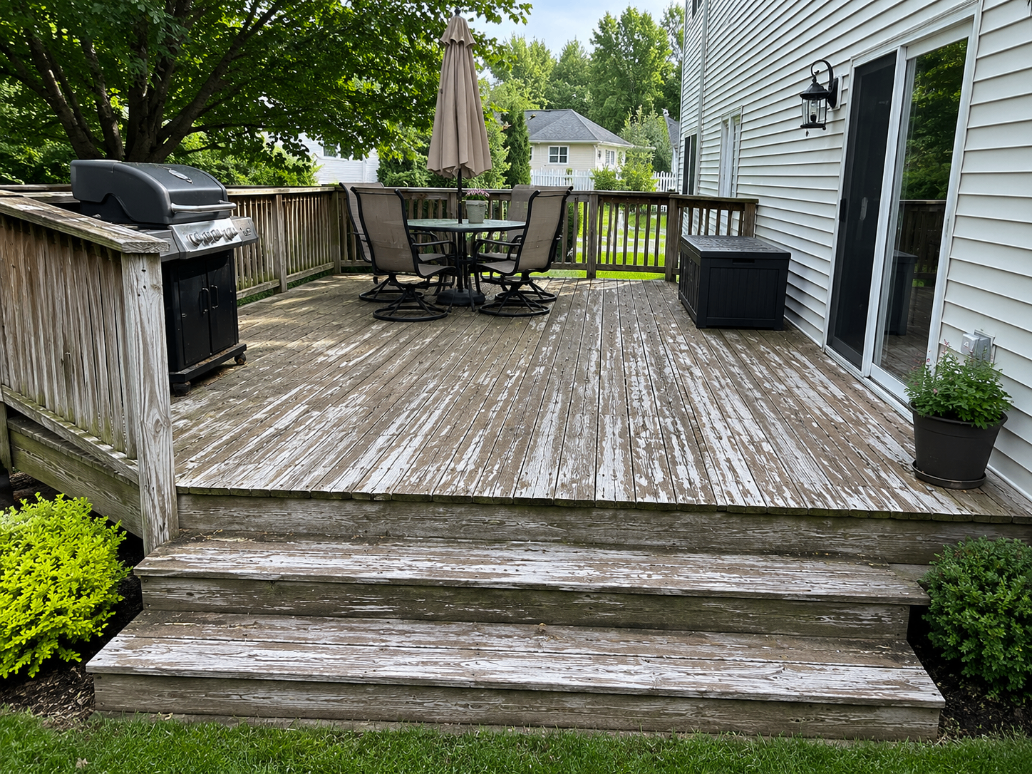 Deck before refinishing with weathered boards in Moorestown backyard