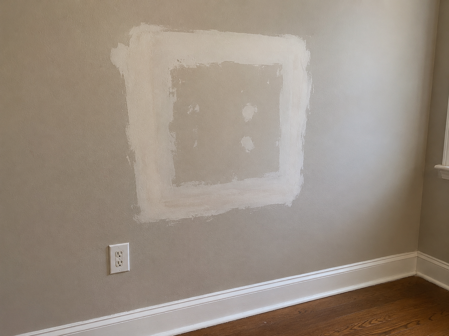 Drywall wall before patch and paint repair with visible compound and unfinished section in Medford