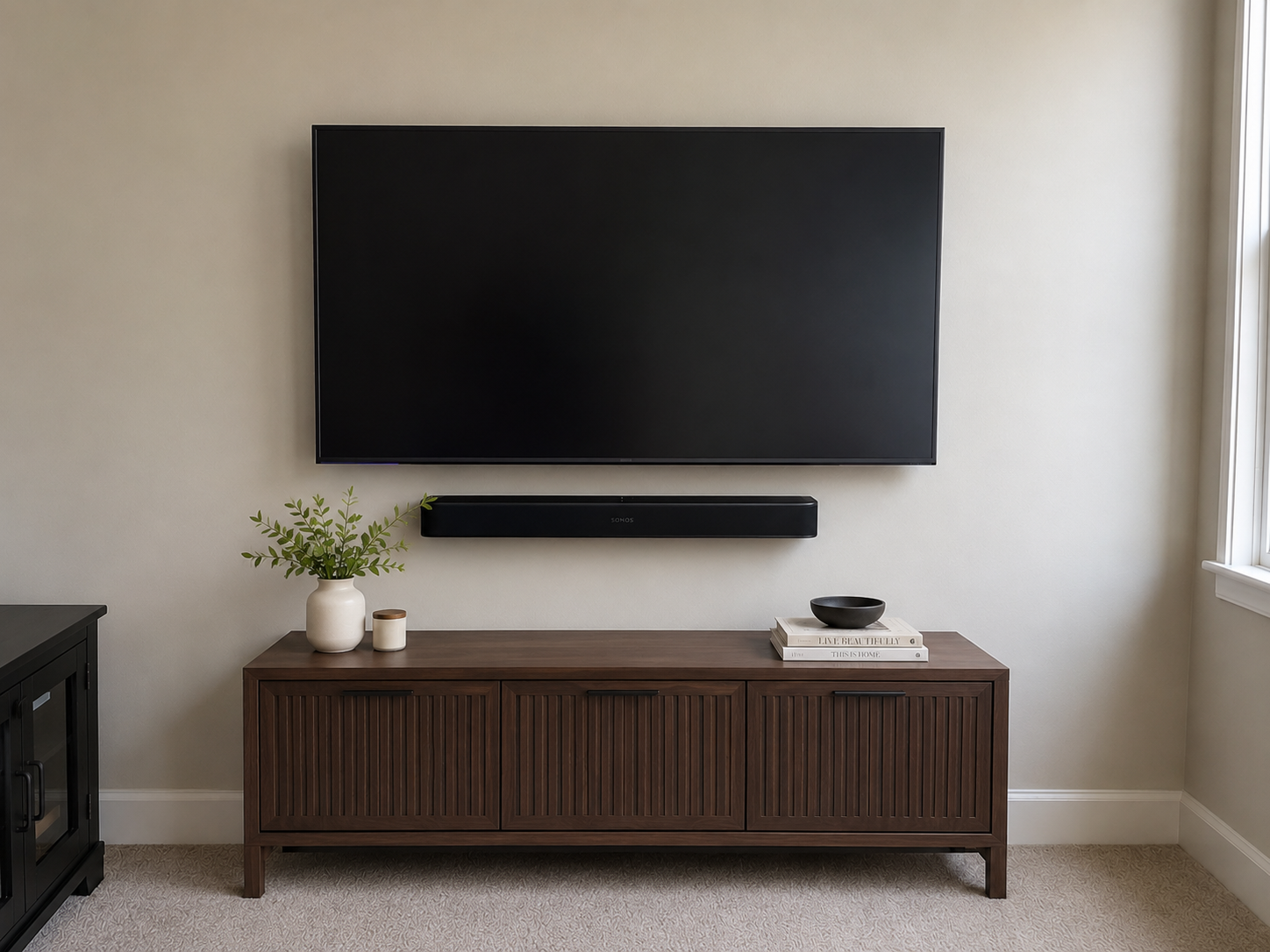 Living room wall after TV mounting with clean cable concealment and soundbar in Lumberton
